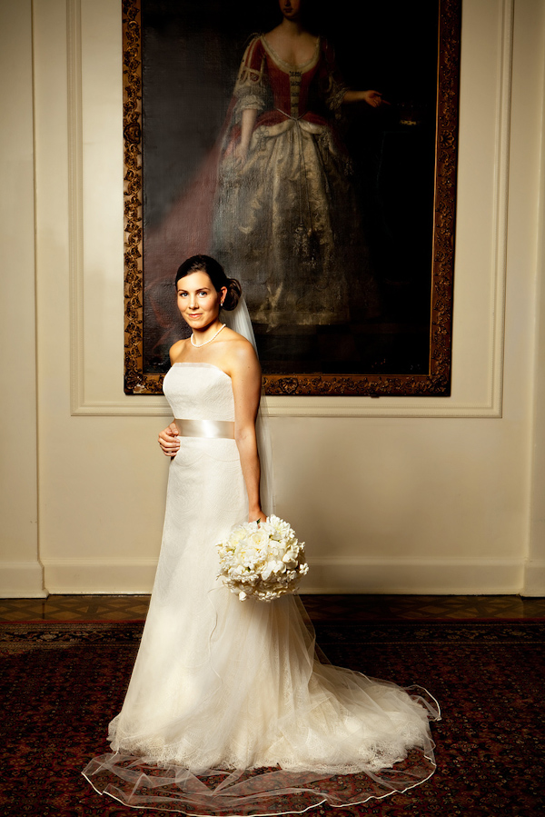 the beautiful bride in a champagne a-line dress with an ivory sash and floral bouquet - photo by North Carolina based wedding photographers Cunningham Photo Artists